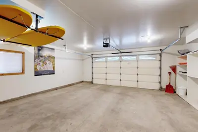 an empty garage with white walls and white garage doors at Sugar Pine Haus in Tahoma