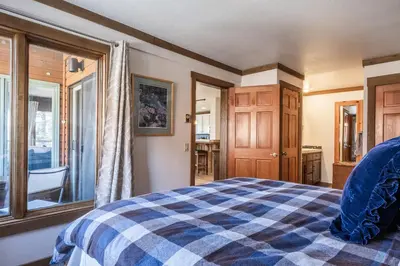 a bedroom with a blue and white checkered bed at Brand New Listing! 5 minute walk to Canyon Lodge! Newly Updated Two-Bed, Two-Bath, Mountainback #14 in Mammoth Lakes