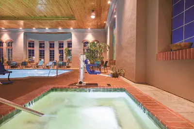 a swimming pool with a hot tub in a building at La Quinta by Wyndham Los Banos in Los Banos