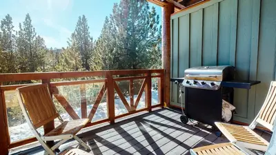 a screened in porch with two chairs and a grill at Juniper Crest #24 townhouse in Mammoth Lakes