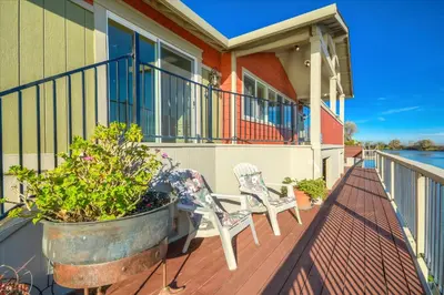 a porch with a chair and a potted plant at Year-round fishing, boating, birding, 1 hr from SF in Walnut Grove