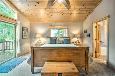 a bedroom with a bed with a wooden ceiling at Bikes, Grill and Views Luxe Truckee Cabin! in Truckee