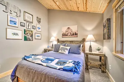 a bedroom with a bed and some pictures on the wall at Bikes, Grill and Views Luxe Truckee Cabin! in Truckee