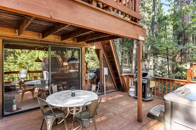 a wooden deck with a table and chairs on it at Heavenly Daze in Arnold