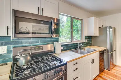 a kitchen with a stove and a sink at Cozy Retreat with Deck about 2 Mi to Pinecrest Lake! in Strawberry