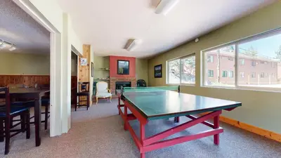 a dining room with a ping pong table in a room at Mammoth View Villas #3 condo in Mammoth Lakes