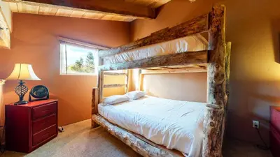 a bedroom with two bunk beds and a window at Mammoth View Villas #3 condo in Mammoth Lakes