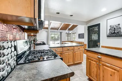 a large kitchen with a stove top oven at Arnold Family Cabin with Hot Tub, Arcade and Deck in Arnold