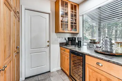 a kitchen with a counter top and a window at Arnold Family Cabin with Hot Tub, Arcade and Deck in Arnold