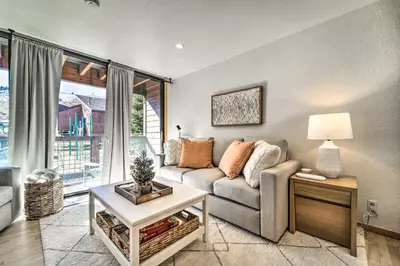a living room with a couch and a table at Walk to Ski Resort Tahoe Donner Studio with Balcony in Truckee
