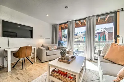 a living room with a couch and a table at Walk to Ski Resort Tahoe Donner Studio with Balcony in Truckee