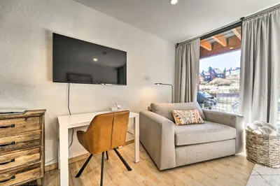 a room with a desk and a chair and a television at Walk to Ski Resort Tahoe Donner Studio with Balcony in Truckee