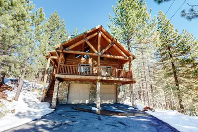 a log cabin in the woods in the snow at Kia Ora Northwoods in Truckee