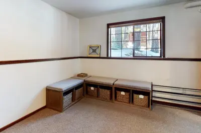 an empty room with two benches and a window at Kia Ora Northwoods in Truckee