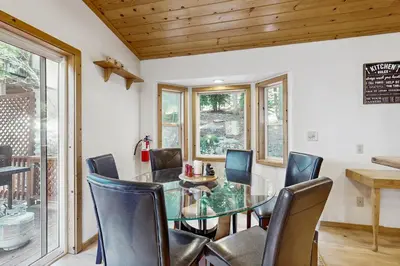 a dining room with a glass table and chairs at Laurelwood Manor in Truckee