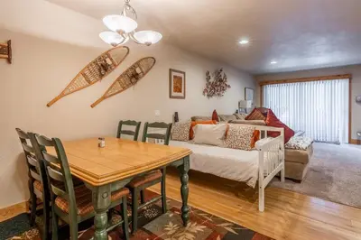 a living room with a table and a couch at New Listing Updated 1 bedrm 1 bath Summit H Building #95 condo Just steps to Eagle Lodge sleeps 4 in Mammoth Lakes