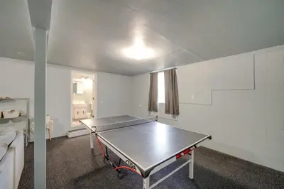 a ping pong table in the middle of a room at Quiet Sequoia National Forest Cabin with Fireplace in Posey