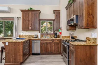 a kitchen with wooden cabinets and granite counter tops at Devonshire - Aberdeen in Yosemite West