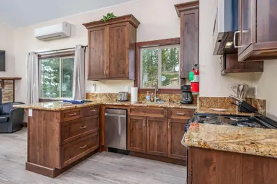 a large kitchen with wooden cabinets and counters at Devonshire - Aberdeen in Yosemite West