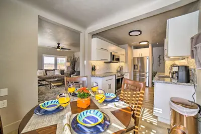 a kitchen and a dining room with a table and chairs at Game Room and Putting Green Reno Home! in Reno