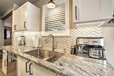 a kitchen with a sink and a counter top at Game Room and Putting Green Reno Home! in Reno