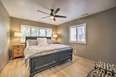 a bedroom with a bed and a ceiling fan at Game Room and Putting Green Reno Home! in Reno