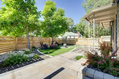 a backyard with a wooden fence and a patio at Game Room and Putting Green Reno Home! in Reno