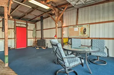 a room with a table and chairs and a red door at Bethel Island Sanctuary with Dock and Boathouse in Oakley