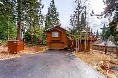 a house with a garage in the middle of a driveway at Tahoe's Stunner in Tahoe Vista