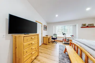 a bedroom with a large flat screen tv on a dresser at Tahoe's Stunner in Tahoe Vista