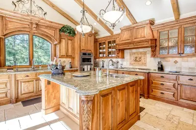 a kitchen with wooden cabinets and a large island at Alpine Luxury in Zephyr Cove