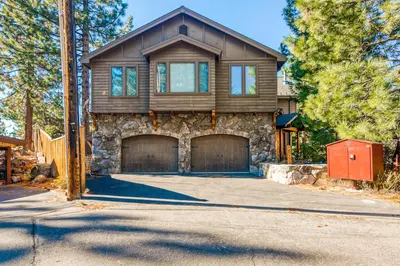 a house with two garage doors on a driveway at Alpine Luxury in Zephyr Cove