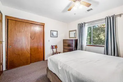 a bedroom with a large bed and a window at Redwood Escape in Arnold