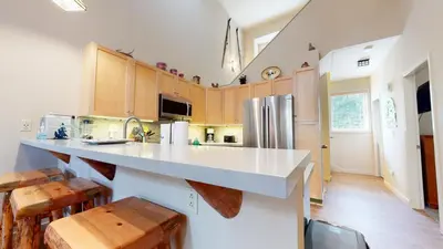 a kitchen with a white counter top and wooden cabinets at Mammoth Green #214 condo in Mammoth Lakes