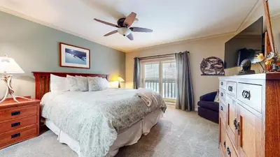 a bedroom with a bed and a ceiling fan at Mammoth Green #214 condo in Mammoth Lakes
