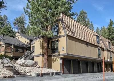 a large house with a tree in front of it at Two-Bedroom Apartment in Mammoth Lakes