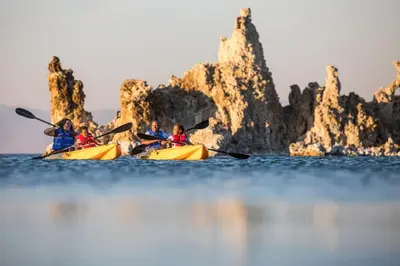 a group of people kayaking on the water near rocks at Mammoth Sierra Townhome in Mammoth Lakes