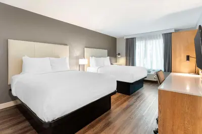 a hotel room with two beds and a sink at Best Western Plus Rancho Cordova Inn in Rancho Cordova