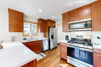 a kitchen with wooden cabinets and a stove top oven at Truckee Secret in Truckee