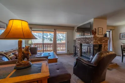 a living room with a couch and a fireplace at Rr-interlaken 19 in June Lake