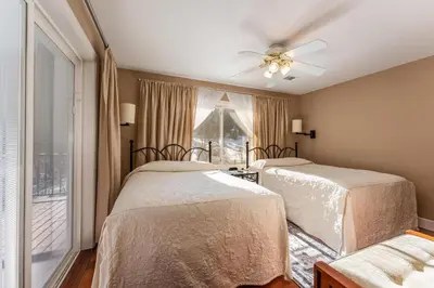 a bedroom with two beds and a window at Big Creek Inn in Fish Camp