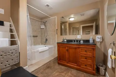 a bathroom with a tub and a sink and a shower at Big Creek Inn in Fish Camp