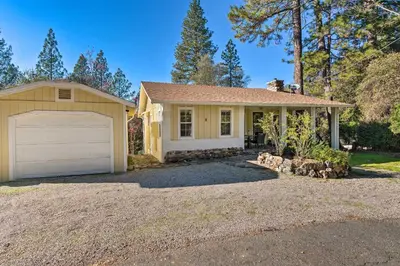 a small yellow house with a garage at Wine Country Escape with Hot Tub in River Pines! in River Pines