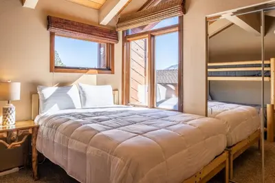 a bedroom with a large bed and a window at Sunrise 9 in Mammoth Lakes