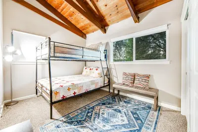 a bedroom with bunk beds and a rug at Wildflower Landing in Groveland