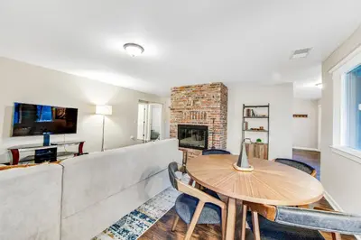 a living room with a couch and a table and a fireplace at Wildflower Landing in Groveland