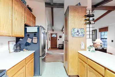 a kitchen with a refrigerator and wooden cabinets at Hikers Haven in Arnold