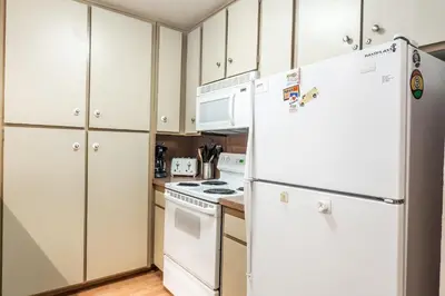 a kitchen with white appliances and white cabinets at New Listing 2 bedroom and Loft 2 bath Summit E Bldg 16 condo sleeps 8 Steps to Eagle Lodge Chair 15 in Mammoth Lakes