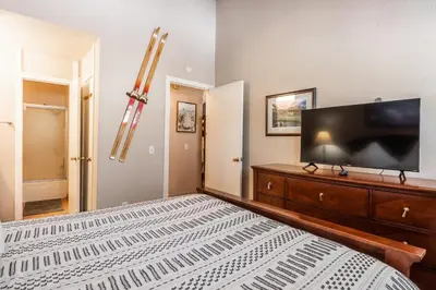 a bedroom with a bed and a flat screen tv at New Listing 2 bedroom and Loft 2 bath Summit E Bldg 16 condo sleeps 8 Steps to Eagle Lodge Chair 15 in Mammoth Lakes