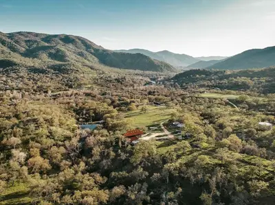 an aerial view of a house in the middle of a forest at Matanah Meadows Farm, Great for 2 Families, Sequoia National Park and Working Farm in Three Rivers